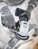A person wearing safety gloves is using a cordless angle grinder to cut a metal pipe, with sparks flying. Produktbild-Vorschau