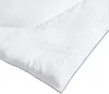 A close-up view of a white duvet with a subtle butterfly pattern embossed on it. Produktbild-Vorschau