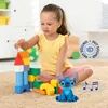 A young girl is playing with colorful building blocks and a Stitch plush toy. Náhľad obrázku produktu