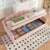 A pink upholstered bed with open storage drawers filled with neatly folded items. Produktbild-Vorschau
