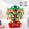 A LEGO model of a lucky chestnut tree, decorated with oranges and coins, sits on a red base. Produktbild-Vorschau