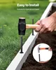 A person is using a hammer to install a ground anchor into a raised garden bed. Podgląd zdjęcia produktu