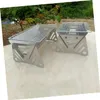 Two portable stainless steel grills are displayed on a marble-like surface, with greenery in the background. Anteprima dell’immagine prodotto