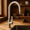 A modern kitchen sink area with a white flexible faucet. Produktbild-Vorschau
