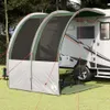 A tarp awning attached to a camper trailer in a grassy, wooded area. Anteprima dell’immagine prodotto