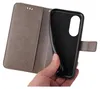 A hand holding a gray flip phone case open, revealing the black interior where a phone would be placed. Produktbild-Vorschau