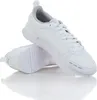 A pair of white Puma sneakers is shown from a slightly elevated side angle, with one shoe placed on top of the other. The background is plain white, and the shoes are reflected on the surface below. Anteprima dell’immagine prodotto