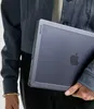 A person holding a laptop case. Produktbild-Vorschau