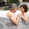 A couple is relaxing in a hot tub outdoors. Produktbild-Vorschau