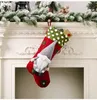 A Christmas stocking hanging on a fireplace mantel. Náhľad obrázku produktu