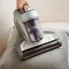 A hand is holding a vacuum cleaner and cleaning a pillow. Náhled obrázku produktu