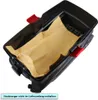 A black vacuum cleaner dustbin with a brown paper bag inside, shown from a high angle. Produktbild-Vorschau