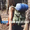 A person wearing a backpack in a forest setting. Podgląd zdjęcia produktu