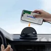 A hand is placing a smartphone with navigation displayed on a car dashboard mount. Náhled obrázku produktu