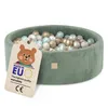 A green corduroy ball pit filled with colorful balls, with a tag attached. Podgląd zdjęcia produktu