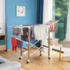A laundry drying rack with clothes is set up in a room with blue walls and a window. Náhľad obrázku produktu