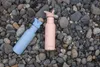 Two water bottles on a bed of stones. Produktbild-Vorschau