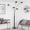 A modern living room with a black floor lamp, a console table with decorative items, and a grey bench. Produktbild-Vorschau