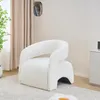 A white armchair is placed on a patterned rug in a room with beige curtains. Anteprima dell’immagine prodotto
