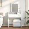 A white vanity table with a mirror and LED lights, a stool, and some decorative items, set up in a bedroom next to a bed. Produktbild-Vorschau