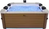 A hot tub filled with bubbling blue water, illuminated by internal lights. Náhled obrázku produktu