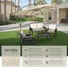 An outdoor patio set with a large cantilever umbrella, sofa, chairs, and coffee table on a green lawn. Produktbild-Vorschau