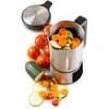 A soup maker with vegetables like tomatoes, carrots, and zucchini arranged around it. Produktbild-Vorschau