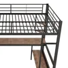 Close-up view of a black metal loft bed with a wooden desk and shelves. Podgląd zdjęcia produktu