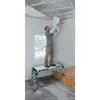 A man is installing ceiling tiles while standing on a work platform. Anteprima dell’immagine prodotto