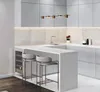 A modern kitchen bar area with light gray cabinets, a marble backsplash, and a white countertop. Náhled obrázku produktu