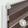 Close-up view of a brown and white striped roller blind attached to a white window frame. Produktbild-Vorschau
