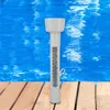 A white pool thermometer floats in blue water next to a wooden deck. Produktbild-Vorschau