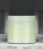 A light green jar of skincare pads sits on a textured surface with a blurred background. Produktbild-Vorschau