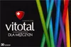 The image shows the front of a product box for a dietary supplement called Vitotal, specifically for men. The box has a black background with colorful vertical stripes on the right side. There is a red shield logo with a white cross on the left side, above Produktbild-Vorschau