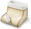 A close-up studio shot of a beige electric foot warmer with a white fluffy lining. Produktbild-Vorschau