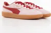 A pair of pink Puma sneakers with red accents and a brown sole, shown from a side angle on a white background. Produktbild-Vorschau