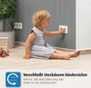 A toddler is playing near an electrical outlet, with a product designed to childproof outlets shown in the foreground. Anteprima dell’immagine prodotto