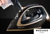 A hand is pouring liquid into a black and gold cordless steam iron. Produktbild-Vorschau