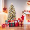 A decorated Christmas tree with presents underneath, next to a fireplace. Podgląd zdjęcia produktu