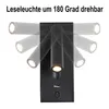 A black wall-mounted lamp with a USB port and power button, shown in various rotational positions. Produktbild-Vorschau