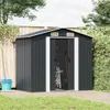 A dark gray metal garden shed with its doors open, showing gardening tools inside. It is situated on a wooden deck with grass in the foreground and a wooden fence and trees in the background. Náhled obrázku produktu