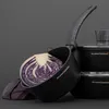 A close-up shot of a black saucepan with a cut red cabbage inside, set against a plain gray background. Other saucepans are visible in the background. Produktbild-Vorschau