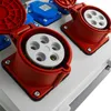 A close-up view of industrial electrical connectors mounted on a panel. Náhled obrázku produktu