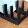 A close-up view of a black plate rack holding a light blue plate. Produktbild-Vorschau