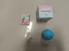 A pet toy ball, its charging cable, a user manual, and its packaging are laid out on a light gray surface. Podgląd zdjęcia produktu