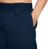 A close-up shot of a person's hand in the pocket of navy blue swim shorts. Podgląd zdjęcia produktu
