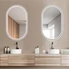 A modern bathroom vanity with two oval mirrors above two sinks. Produktbild-Vorschau