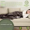 A woman sleeping on a couch under a heated blanket. Produktbild-Vorschau