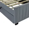 Close-up view of a grey upholstered bed frame with wooden slats. Náhled obrázku produktu