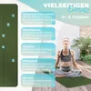 A woman is meditating on a yoga mat outdoors, with diagrams explaining the mat's features. Produktbild-Vorschau